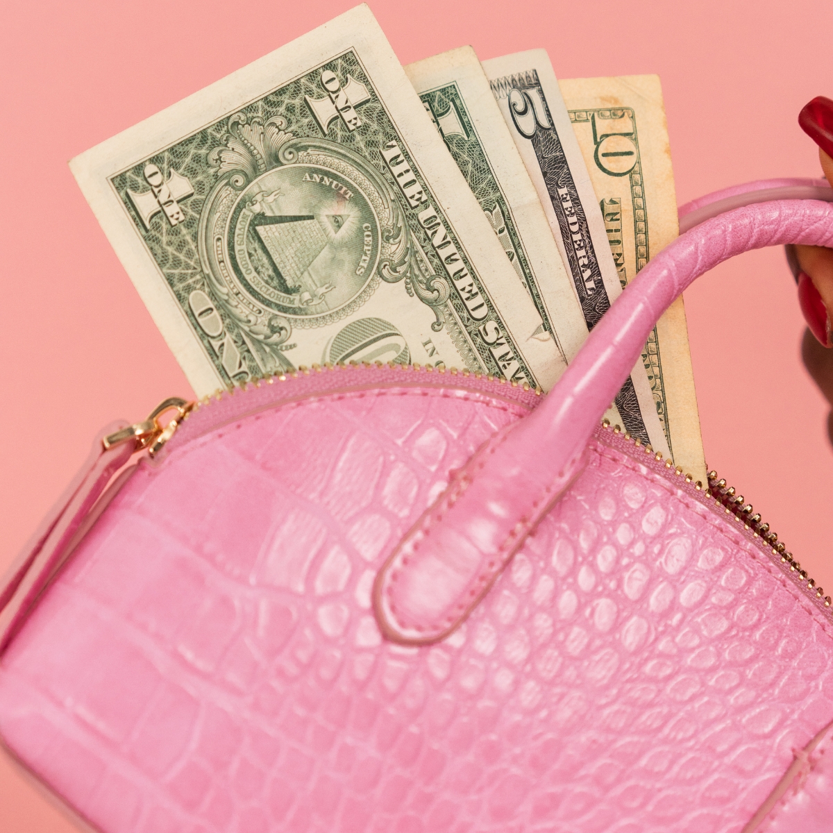 A pink purse with dollars showing how do influencers make money.