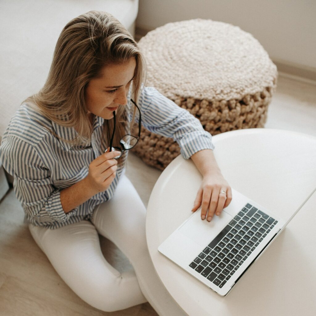 Woman becoming a paid influencer with freelance work on a laptop.