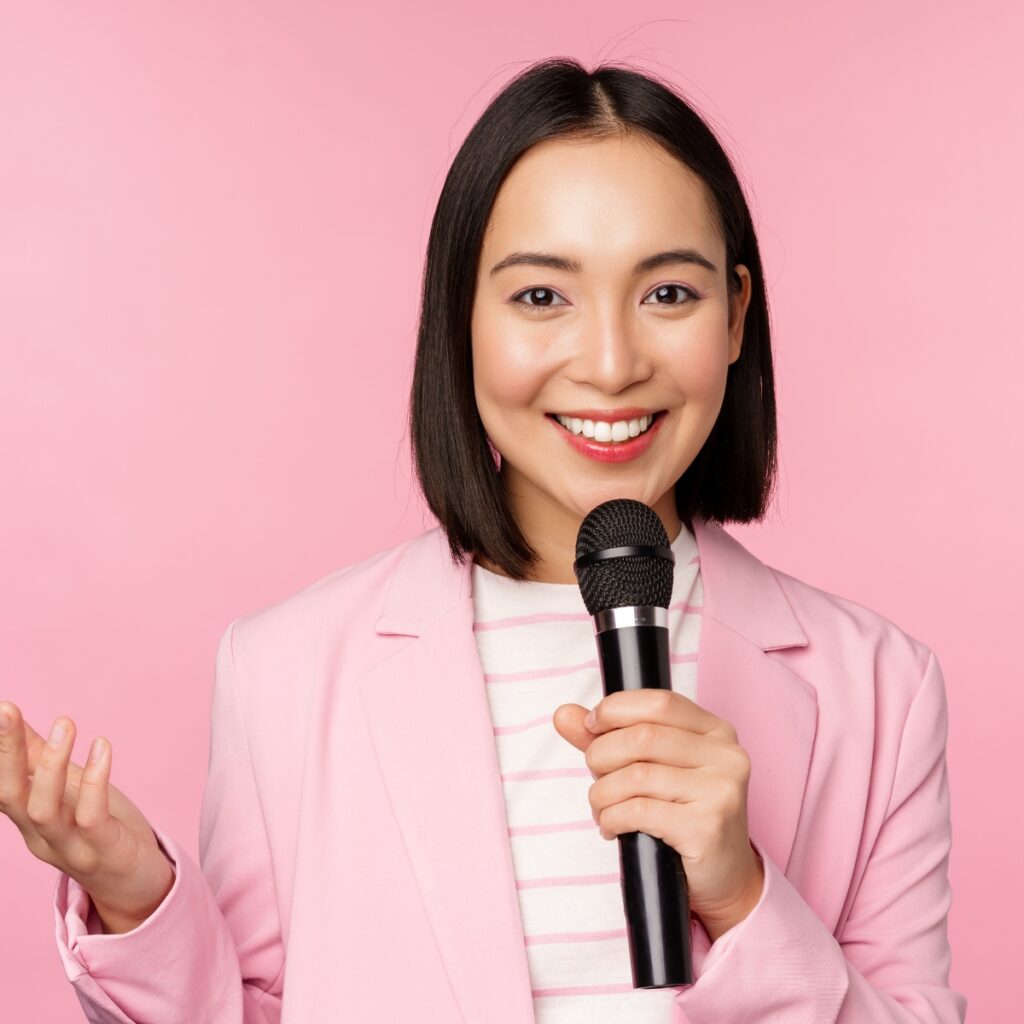 Woman becoming a paid influencer with a microphone ready to speak.