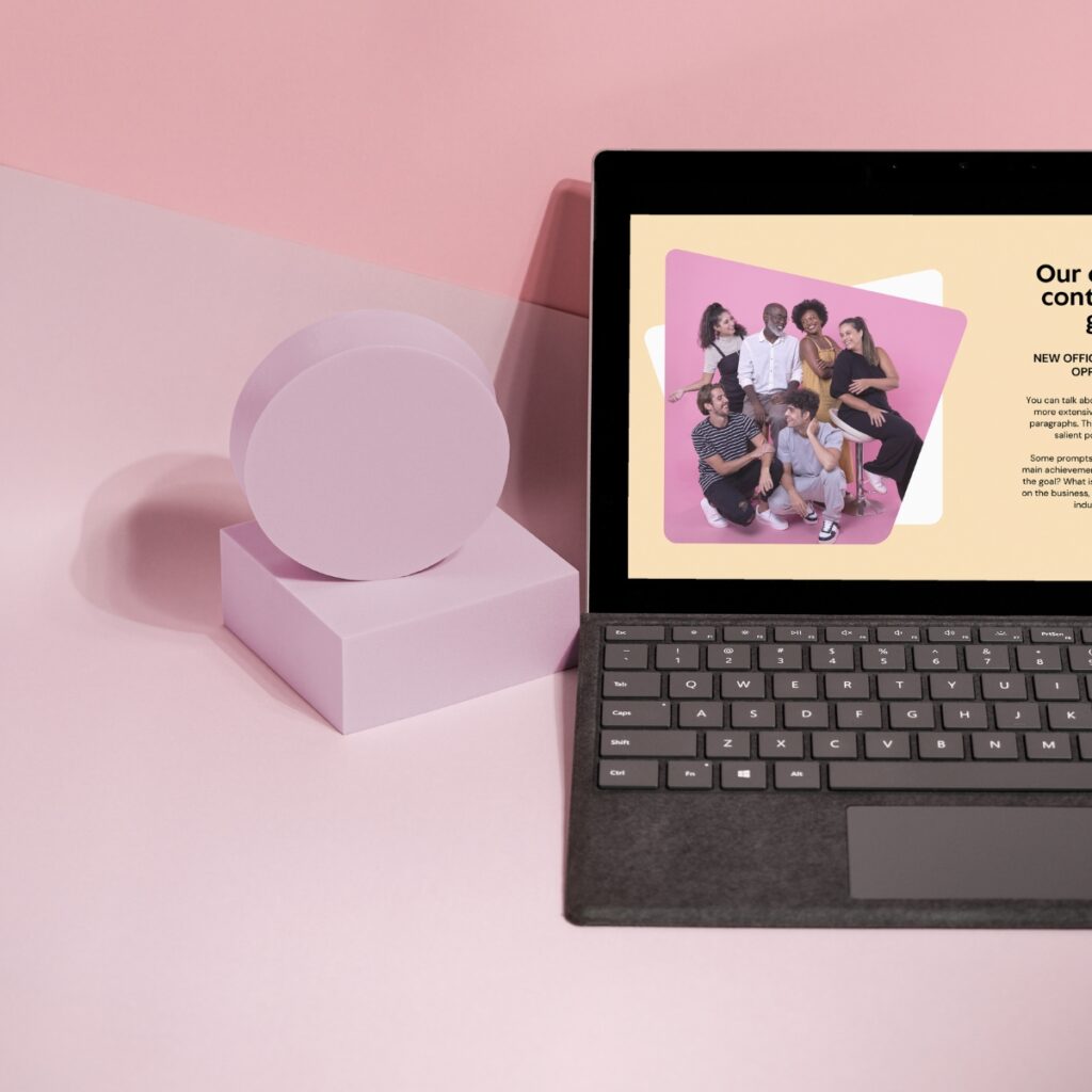 Laptop with about page displayed on a pink table.